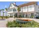 Two-story white home with charming front porch and landscaping at 9844 Haven Loop, Johns Island, SC 29455