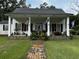 White house with black metal roof and porch at 106 Church St, Reevesville, SC 29471