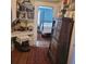 Charming hallway with antique furniture, built-in shelves, and colorful rugs at 106 Church St, Reevesville, SC 29471