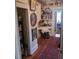 Long hallway with built-in shelves, antique decor, and access to pantry at 106 Church St, Reevesville, SC 29471