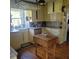 Galley kitchen with butcher block island, farmhouse sink, and granite counters at 106 Church St, Reevesville, SC 29471