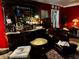 Living room with a red wall, leather chairs, and an ornate bar at 106 Church St, Reevesville, SC 29471