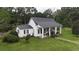 White house with black metal roof and porch at 106 Church St, Reevesville, SC 29471