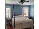 Bright bedroom with a post bed, two windows, and ceiling fan at 106 Church St, Reevesville, SC 29471