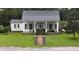 White house with black metal roof and porch at 106 Church St, Reevesville, SC 29471