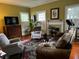 Spacious living room with hardwood floors, comfortable seating, and a fireplace at 106 Church St, Reevesville, SC 29471