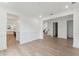Open living room with hardwood floors and views into the kitchen and staircase at 1691 Cultivation Lane Way # 462, Mount Pleasant, SC 29466