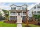 Two-story home with white siding, gray accents, and a front porch at 1691 Cultivation Lane Way # 462, Mount Pleasant, SC 29466