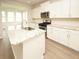 Modern kitchen with white cabinets, granite counters, and island at 173 Cantona Dr, Summerville, SC 29483
