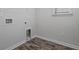 Bright laundry room with vinyl flooring, built-in cabinets, and hook at 173 Cantona Dr, Summerville, SC 29483