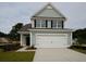 Two-story house with light green siding and white garage door at 173 Cantona Dr, Summerville, SC 29483