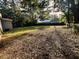Large backyard with lush grass and mature trees at 7629 Pinehurst St, North Charleston, SC 29420