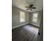 Well-lit bedroom with hardwood floors and ample natural light at 7629 Pinehurst St, North Charleston, SC 29420