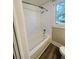 Clean bathroom featuring a bathtub, shower, and grab bar at 7629 Pinehurst St, North Charleston, SC 29420