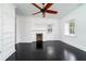 Bedroom with dark hardwood floors, ceiling fan, built-in cabinets, and fireplace at 106 Church St # D, Charleston, SC 29401