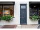 Building's front door, flanked by businesses at 106 Church St # D, Charleston, SC 29401