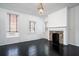 Spacious living room with fireplace, dark hardwood floors, and large windows at 106 Church St # D, Charleston, SC 29401