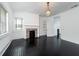 Living room with fireplace, dark hardwood floors, and French doors at 106 Church St # D, Charleston, SC 29401