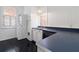 Kitchen with white cabinets, dark countertop, and stackable washer/dryer at 106 Church St # D, Charleston, SC 29401