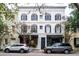 Two-story building with commercial spaces and dark shutters at 106 Church St # D, Charleston, SC 29401