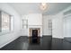 Living room with fireplace, dark hardwood floors, and built-in shelving at 106 Church St # D, Charleston, SC 29401