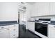 White kitchen with gas range, microwave, and built-in pantry at 106 Church St # D, Charleston, SC 29401