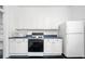 White kitchen with gas range, microwave, and refrigerator at 106 Church St # D, Charleston, SC 29401