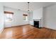 Bright bedroom with hardwood floors, built-in shelving, and fireplace at 106 Church St # D, Charleston, SC 29401