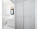 Clean bathroom with white vanity, built-in storage, and black and white tile floor at 106 Church St # D, Charleston, SC 29401