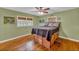 Spacious bedroom with hardwood floors, ceiling fan, and built-in storage at 148 Chadwick Dr, Charleston, SC 29407