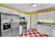Charming kitchen boasts modern appliances and red and white checkered floors at 148 Chadwick Dr, Charleston, SC 29407