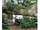 Landscaped garden with mature trees and wooden fence at 148 Chadwick Dr, Charleston, SC 29407