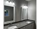 Double vanity bathroom with granite countertops and updated light fixtures at 983 Weeks Ln, Round O, SC 29474