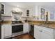 Modern kitchen with stainless steel appliances and granite countertops at 14 Lockwood Dr # 10D, Charleston, SC 29401