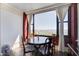 Bright dining room with water views and a round table surrounded by chairs at 14 Lockwood Dr # 10D, Charleston, SC 29401