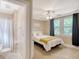 Cozy bedroom with a queen bed, ceiling fan, and access to the bathroom at 525 Parkdale Drive, Charleston, SC 29414