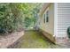 Side yard of the house with green grass and trees at 525 Parkdale Drive, Charleston, SC 29414