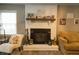 White brick fireplace with a wooden mantel and Gathering photos at 309 Wintergreen Rd, Walterboro, SC 29488