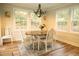 Cozy dining area with wood table, chandelier, and white chairs at 309 Wintergreen Rd, Walterboro, SC 29488