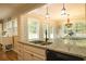 Kitchen boasts granite countertops, double sink, and a view into the dining area at 309 Wintergreen Rd, Walterboro, SC 29488