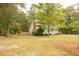 Charming white cottage with a spacious front porch and well-manicured lawn at 309 Wintergreen Rd, Walterboro, SC 29488