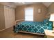 Bright bedroom with white metal bed frame and built-in closet at 309 Wintergreen Rd, Walterboro, SC 29488