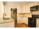 Modern kitchen with granite countertops, white cabinets, and stainless steel appliances at 309 Wintergreen Rd, Walterboro, SC 29488