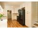 Modern kitchen featuring white cabinets, black appliances, and wood floors at 309 Wintergreen Rd, Walterboro, SC 29488
