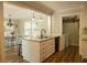 Open concept kitchen with island, white cabinets, and access to dining area at 309 Wintergreen Rd, Walterboro, SC 29488