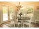 Bright dining room with French doors leading to backyard and a rustic chandelier at 309 Wintergreen Rd, Walterboro, SC 29488