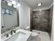 Updated bathroom with gray tile shower and white vanity at 861 Savage Rd, Charleston, SC 29414