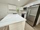 Modern kitchen with white cabinets, stainless steel appliances, and quartz countertops at 861 Savage Rd, Charleston, SC 29414