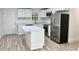 Modern kitchen with white cabinets, island, and stainless steel appliances at 861 Savage Rd, Charleston, SC 29414