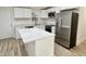 Modern kitchen with white cabinets, stainless steel appliances, and quartz countertops at 861 Savage Rd, Charleston, SC 29414